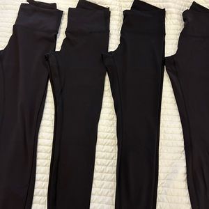 Four pairs of Lululemon used leggings. All are 25 inch, black size 8